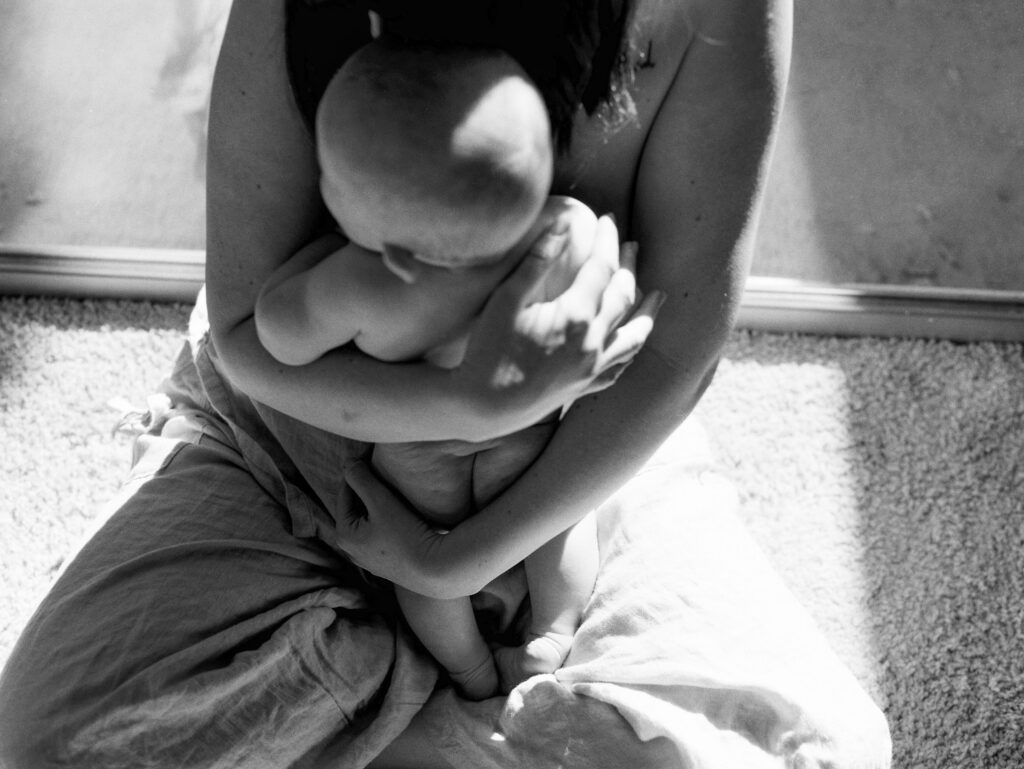 facebook portrait of a mother holding her baby, black and white motherhood image