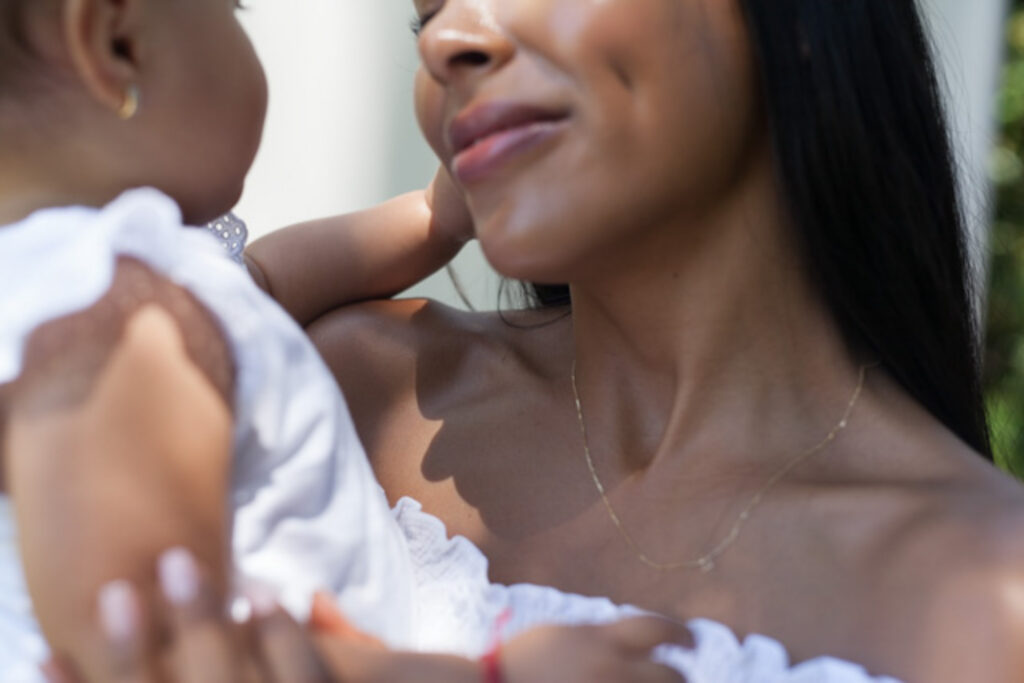 motherhood portrait. mother looking at child.